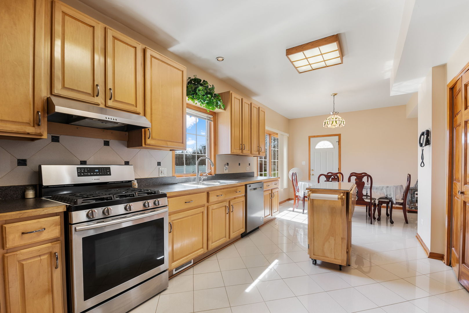 1612 Percy Lane Itasca, IL 60143 - Photo 6 of 20 a kitchen with granite countertop stove top oven and cabinets