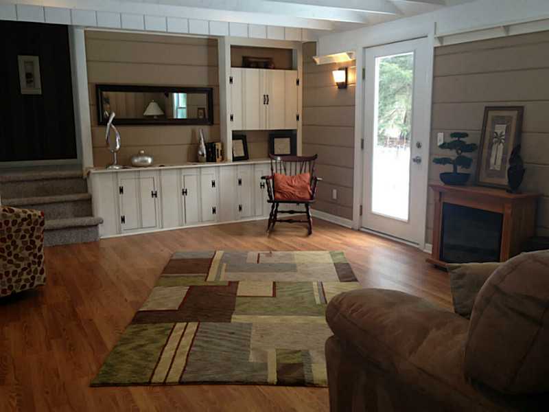 293 Hope Furnace Road Scituate, RI 02831 - Photo 4 of 14 Den/Family/Great Room. This spacious family room is located off the kitchen. Laminate wood flooring,and custom built-ins. Very Charming room! Door opens up to deck and backyard. Over 1/2 acre of privacy.