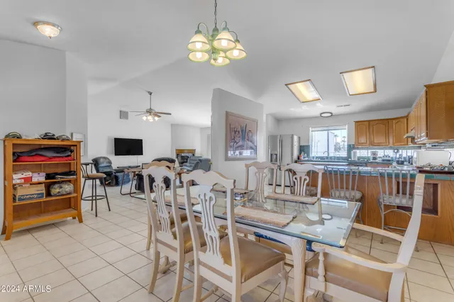 a living room with furniture chandelier and a window