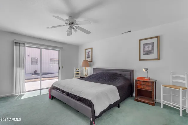 a bathroom with a double vanity sink a toilet a mirror and shower