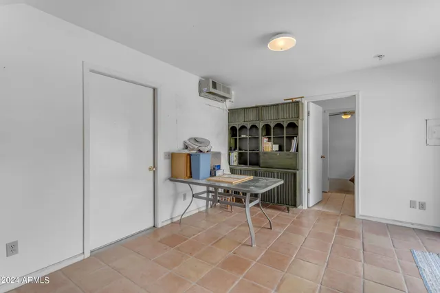 a spacious bedroom with a bed and a fireplace