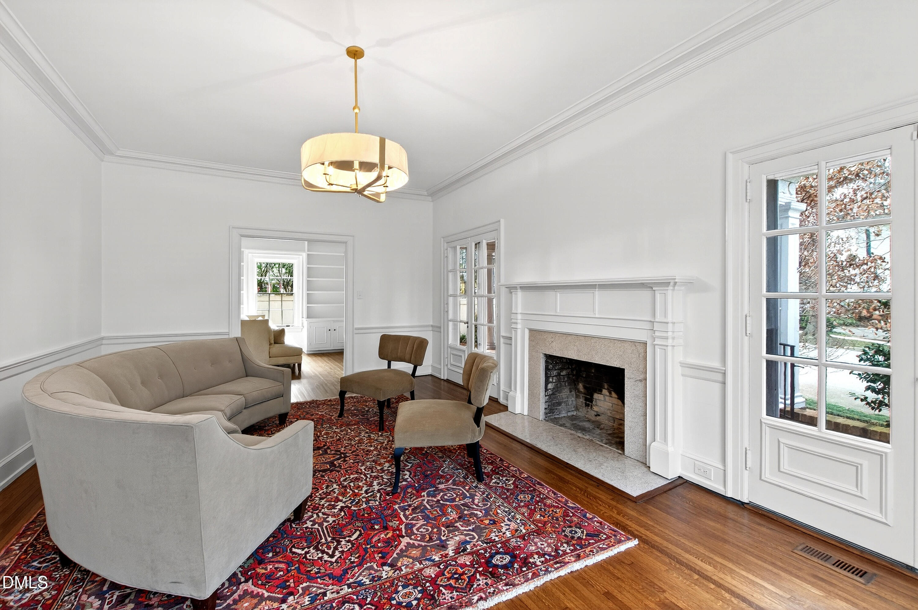 1313 College Place Raleigh, NC 27605 - Photo 21 of 71 a living room with couches a fireplace and a window