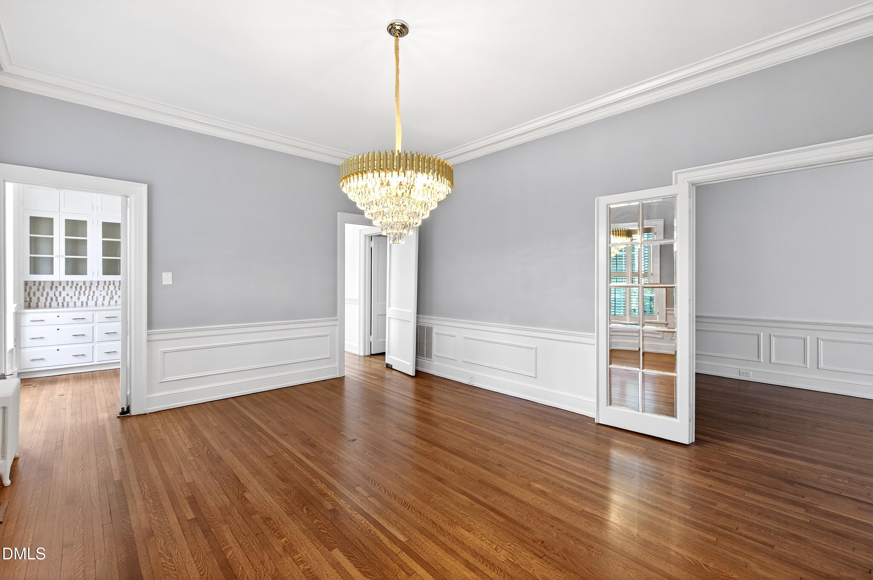 1313 College Place Raleigh, NC 27605 - Photo 34 of 71 a view of an empty room with wooden floor and a window