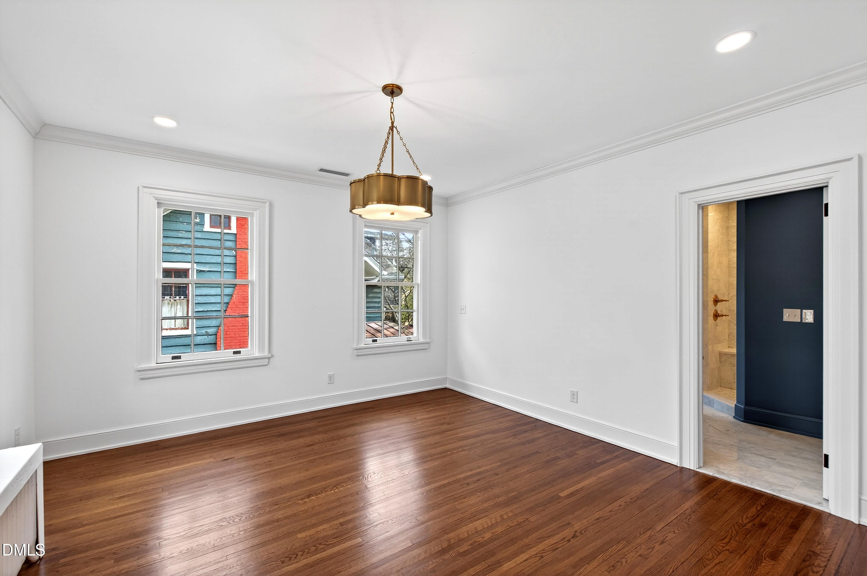 1313 College Place Raleigh, NC 27605 - Photo 40 of 71 an empty room with wooden floor closet and windows