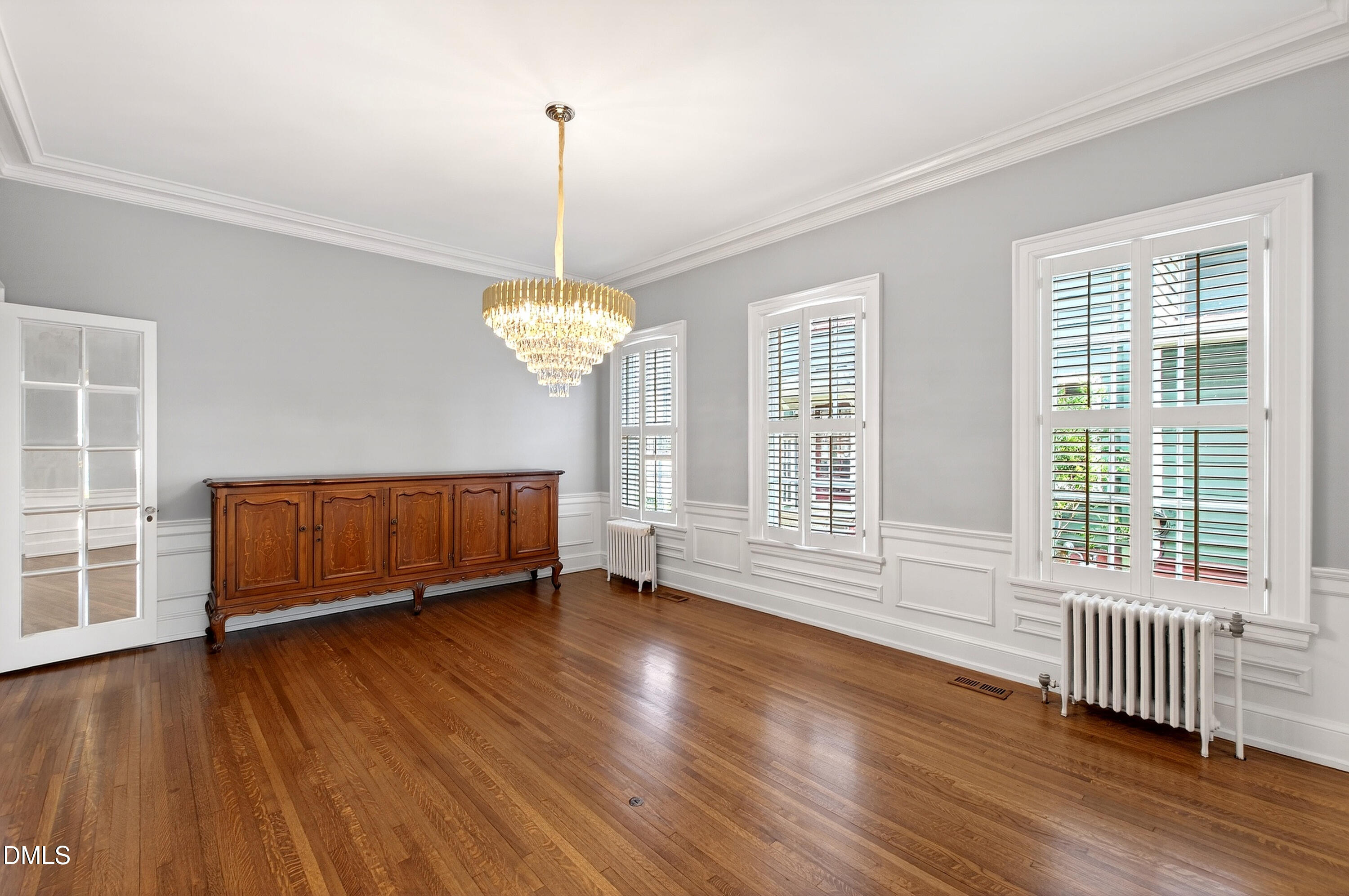 1313 College Place Raleigh, NC 27605 - Photo 4 of 71 a view of an empty room with wooden floor and a window