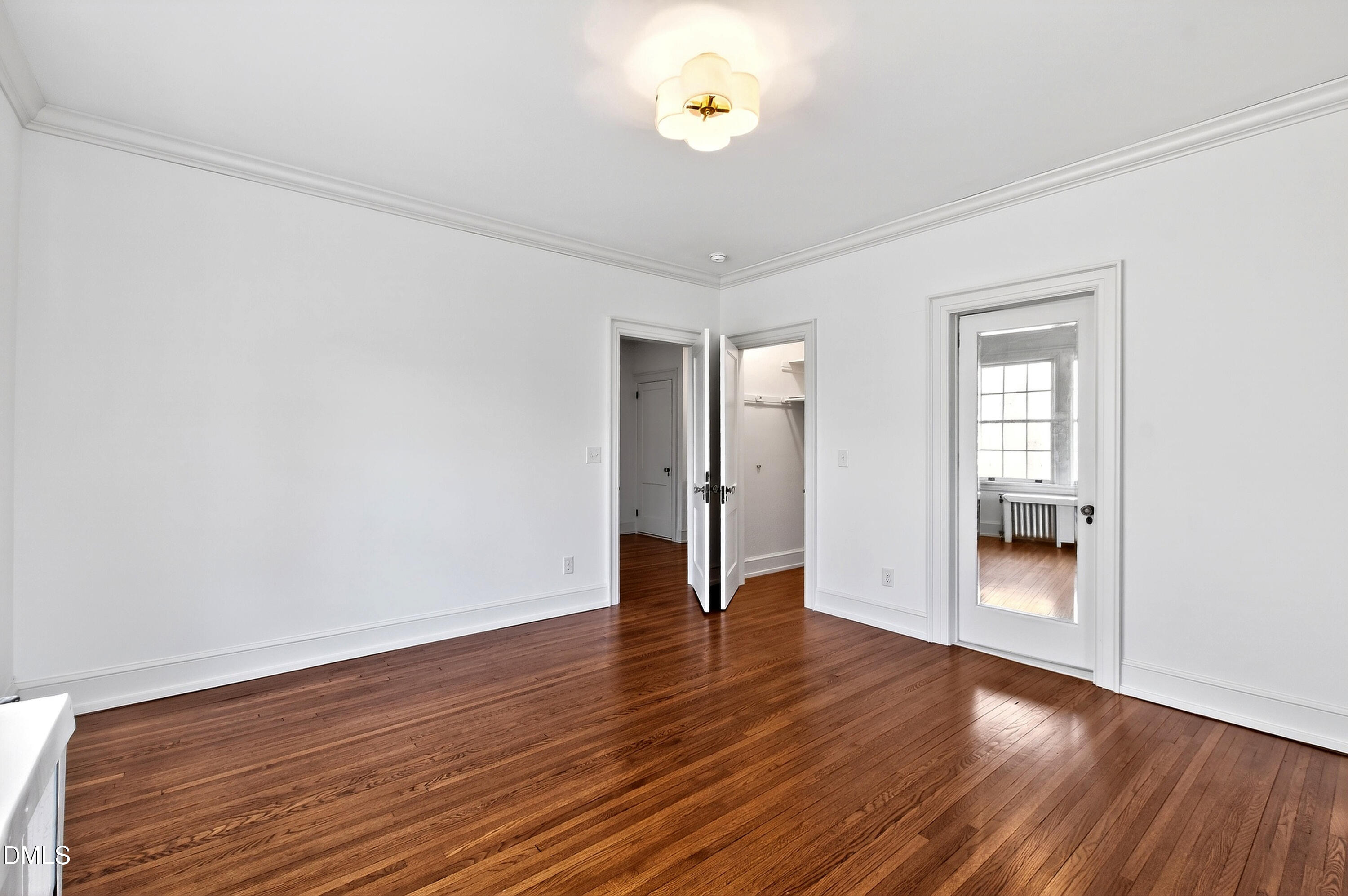 1313 College Place Raleigh, NC 27605 - Photo 47 of 71 a view of an empty room with wooden floor and a window