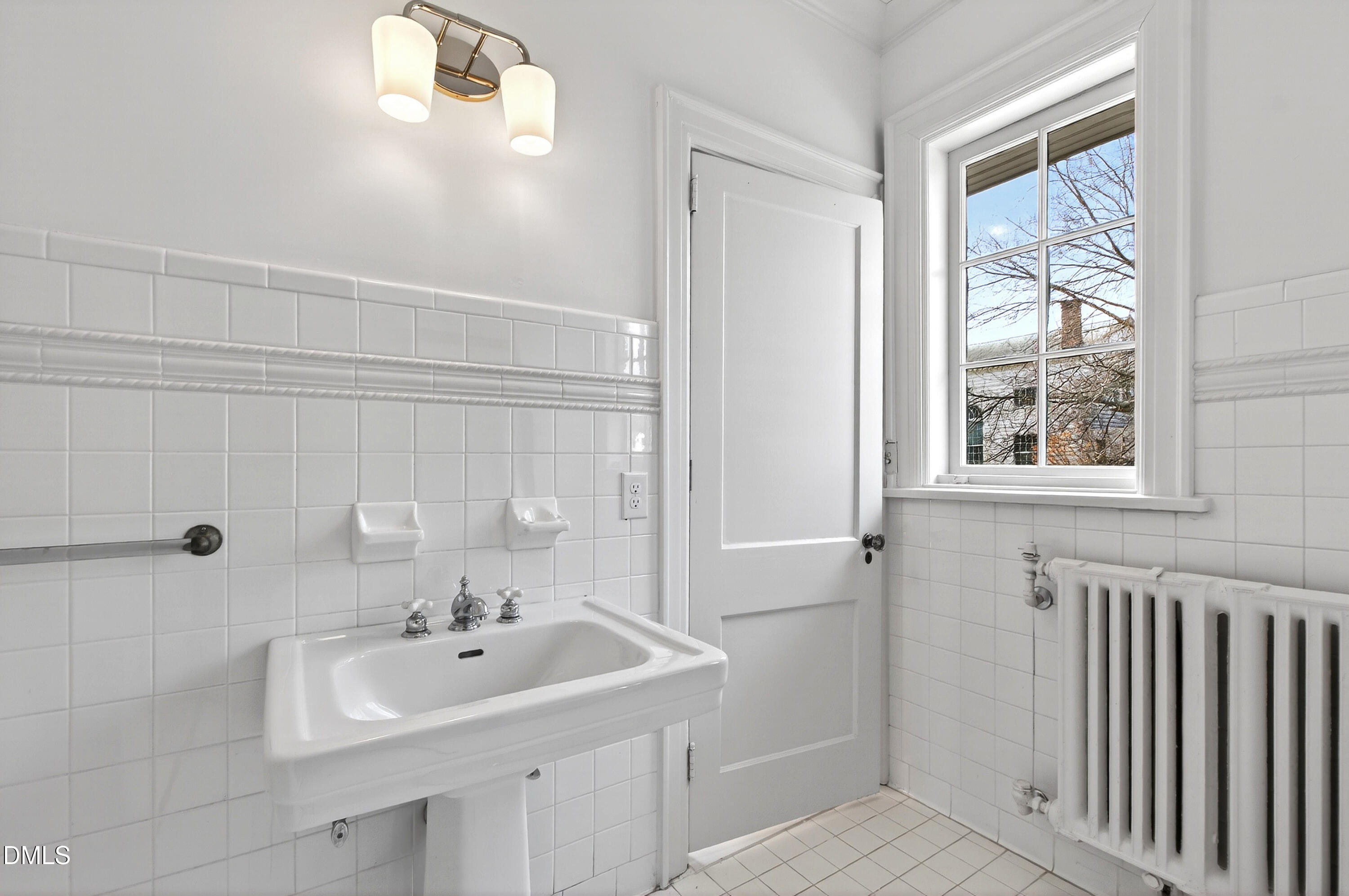 1313 College Place Raleigh, NC 27605 - Photo 48 of 71 a bathroom with a sink and a window