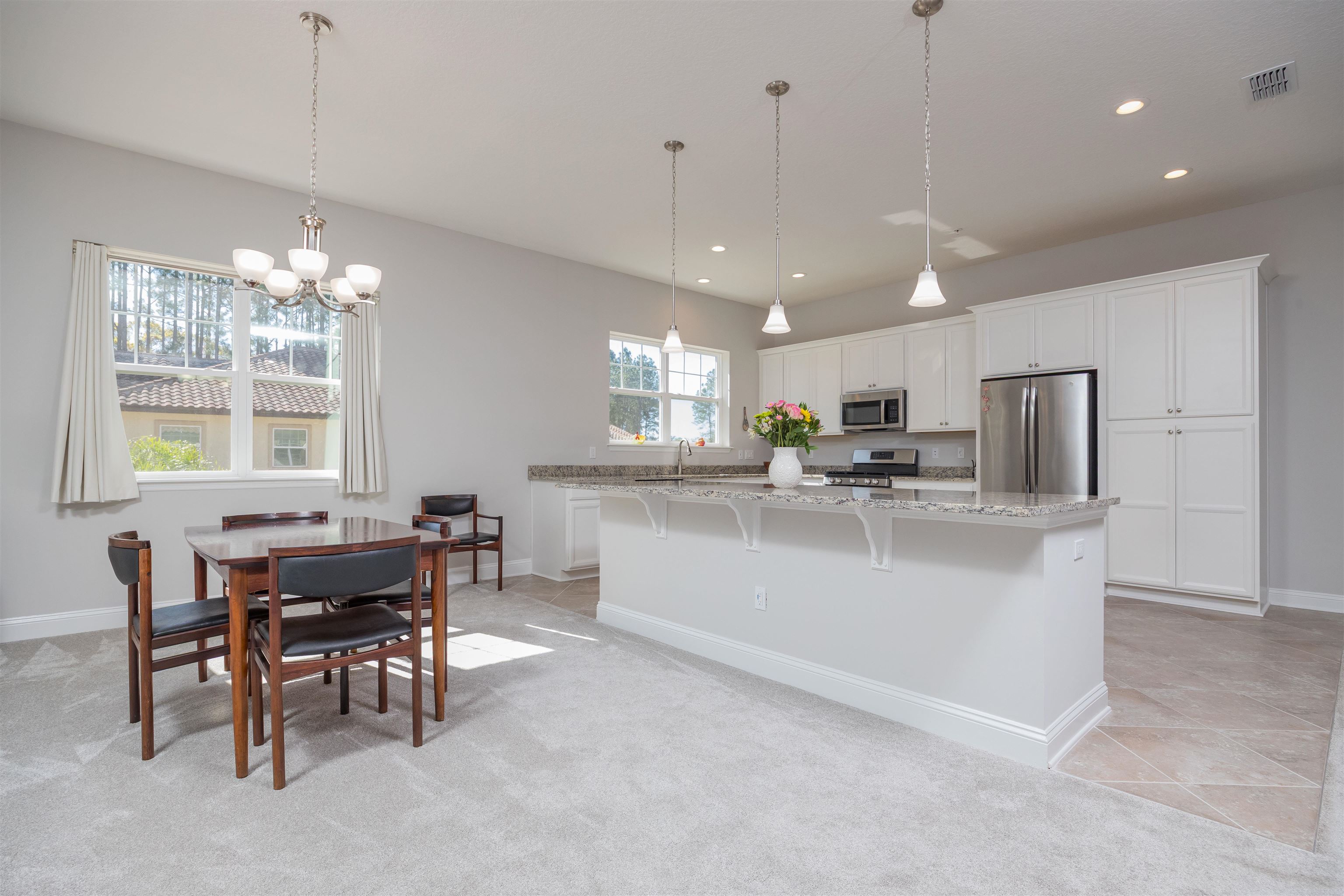 111 CanyonTrail St. Augustine, FL 32086 - Photo 14 of 55 a living room with kitchen island furniture and a chandelier