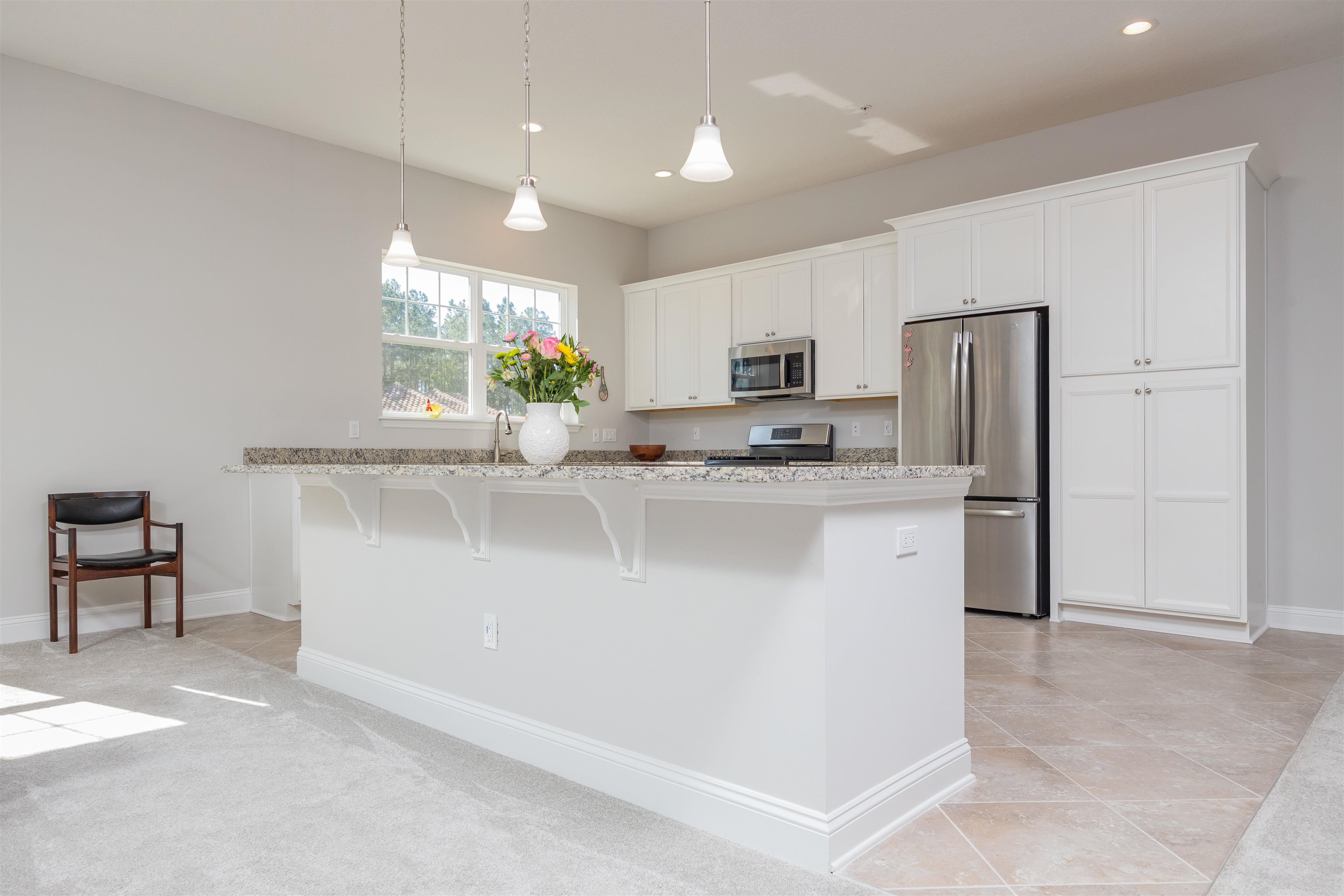 111 CanyonTrail St. Augustine, FL 32086 - Photo 15 of 55 a kitchen with kitchen island granite countertop stainless steel appliances a refrigerator a stove a microwave a sink and a center island