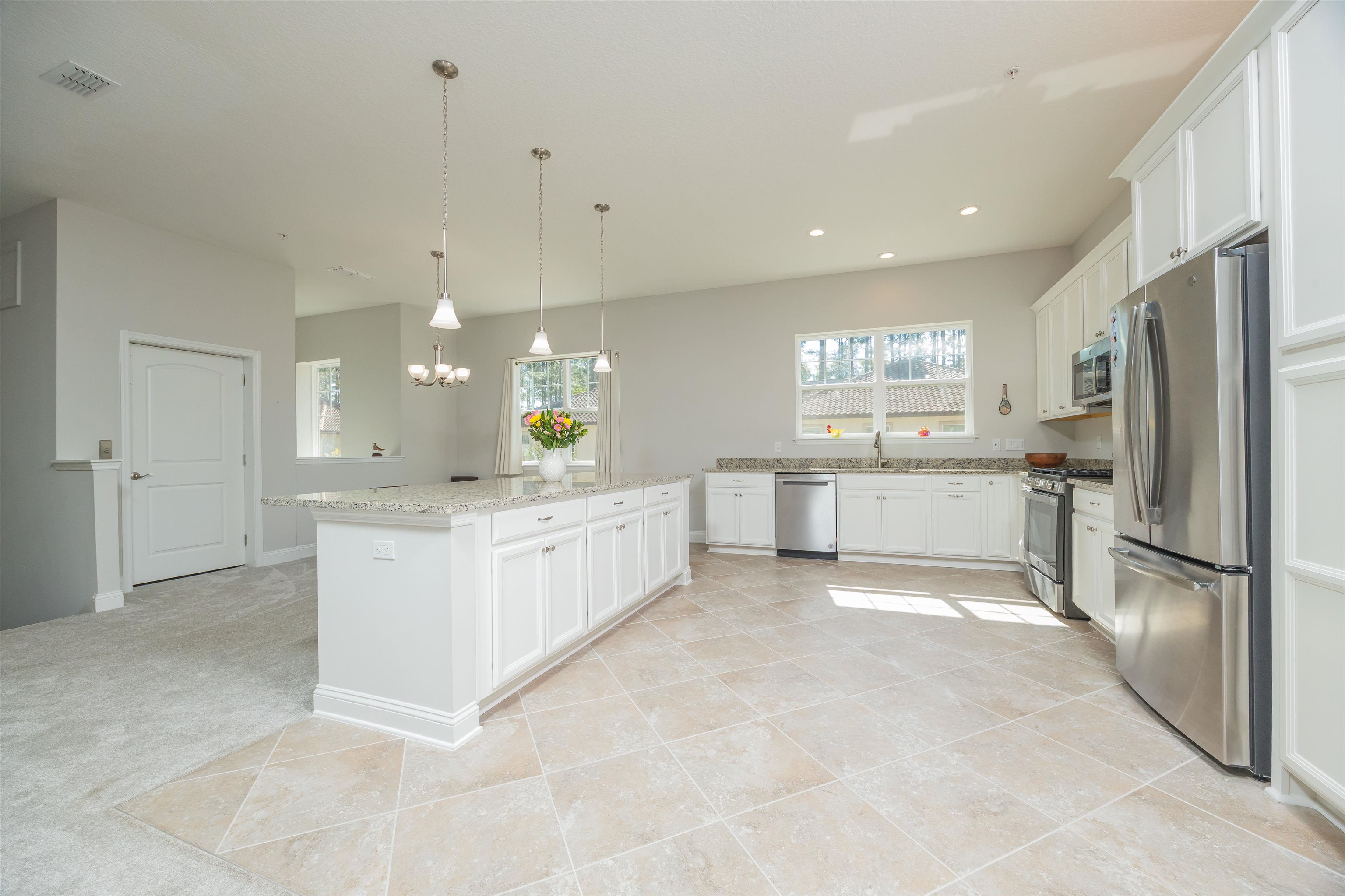 111 CanyonTrail St. Augustine, FL 32086 - Photo 18 of 55 a large white kitchen with a refrigerator a counter top space and cabinets