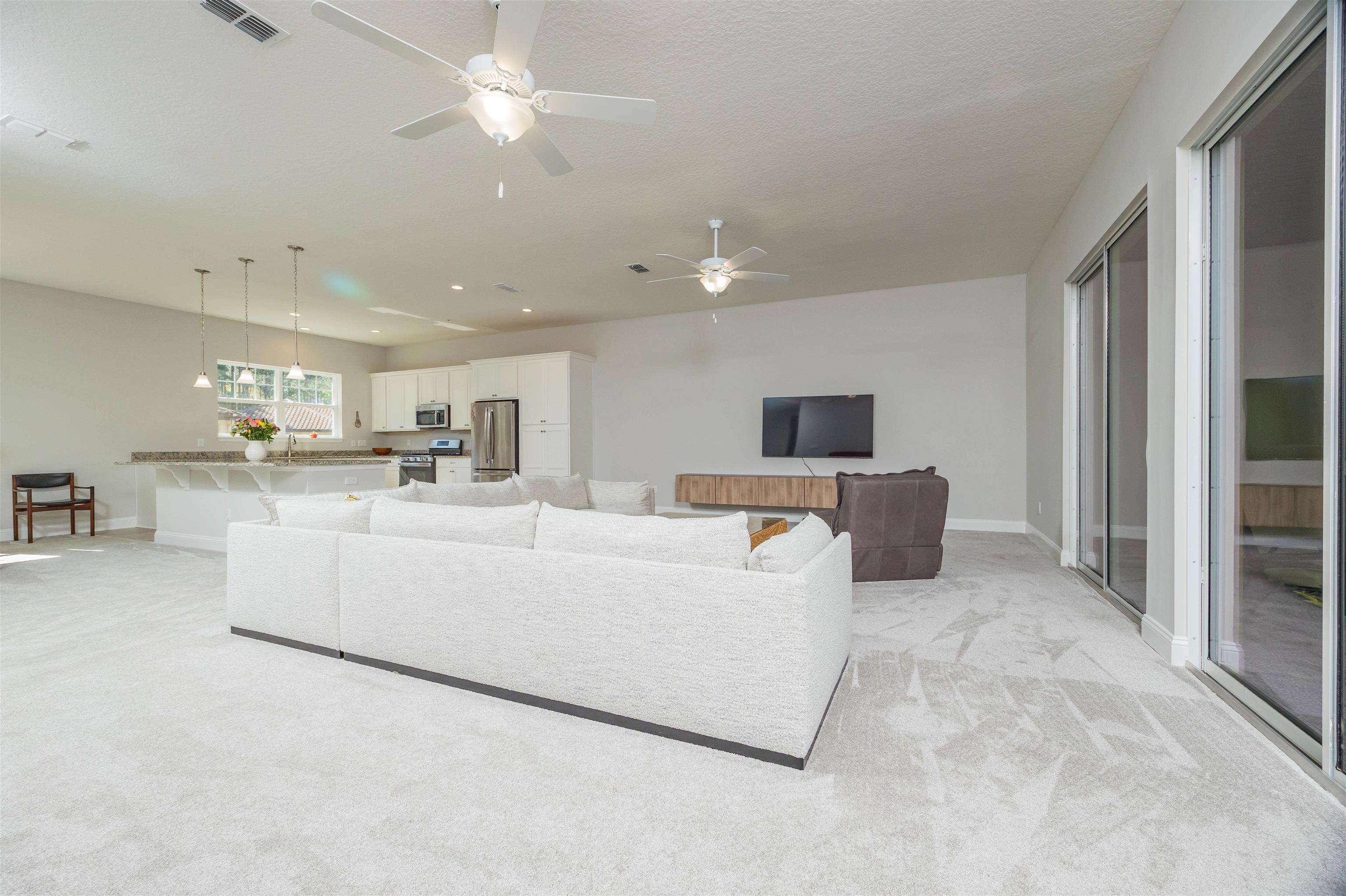 111 CanyonTrail St. Augustine, FL 32086 - Photo 26 of 55 a living room with furniture and a flat screen tv