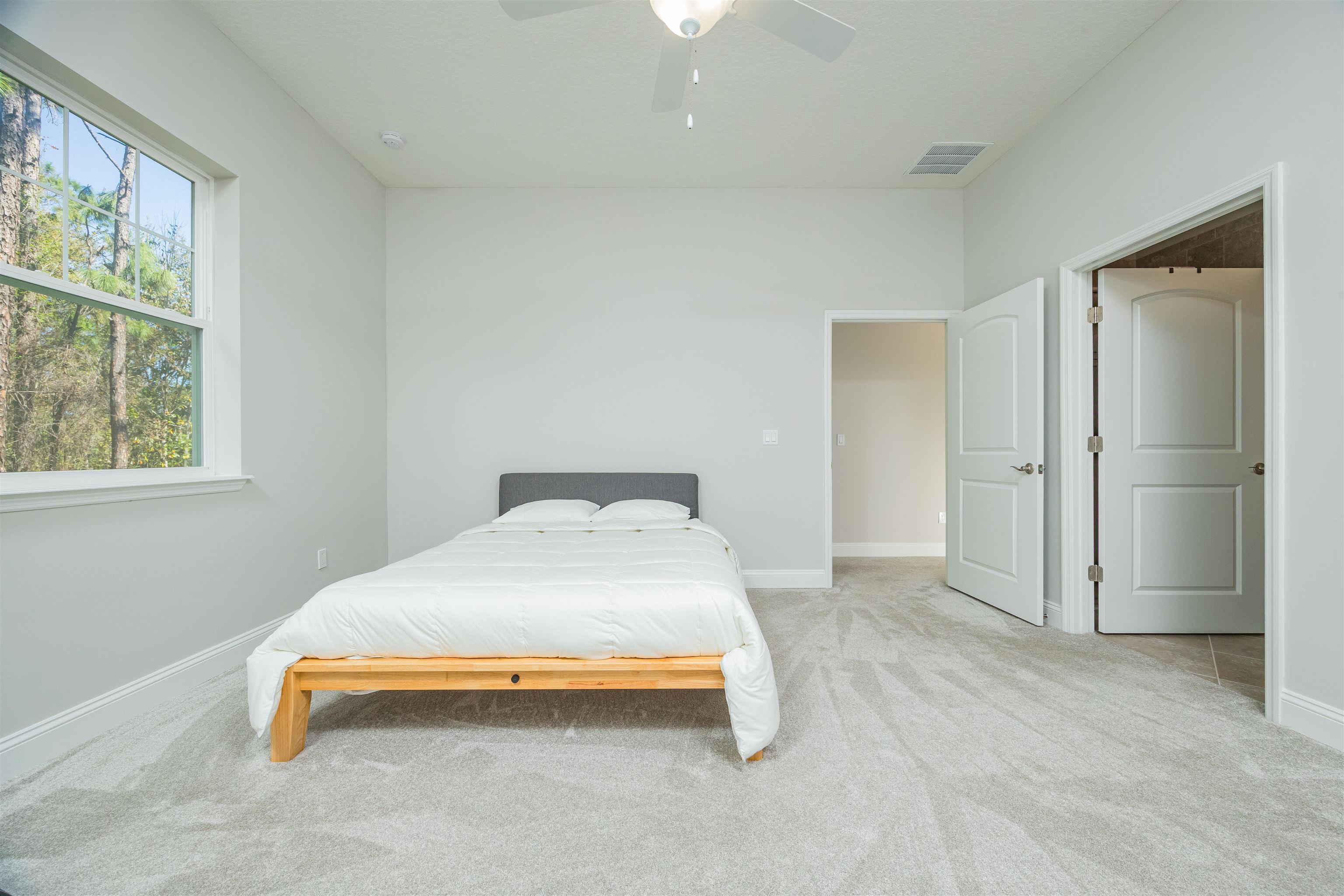 111 CanyonTrail St. Augustine, FL 32086 - Photo 34 of 55 a bedroom with a bed and a window