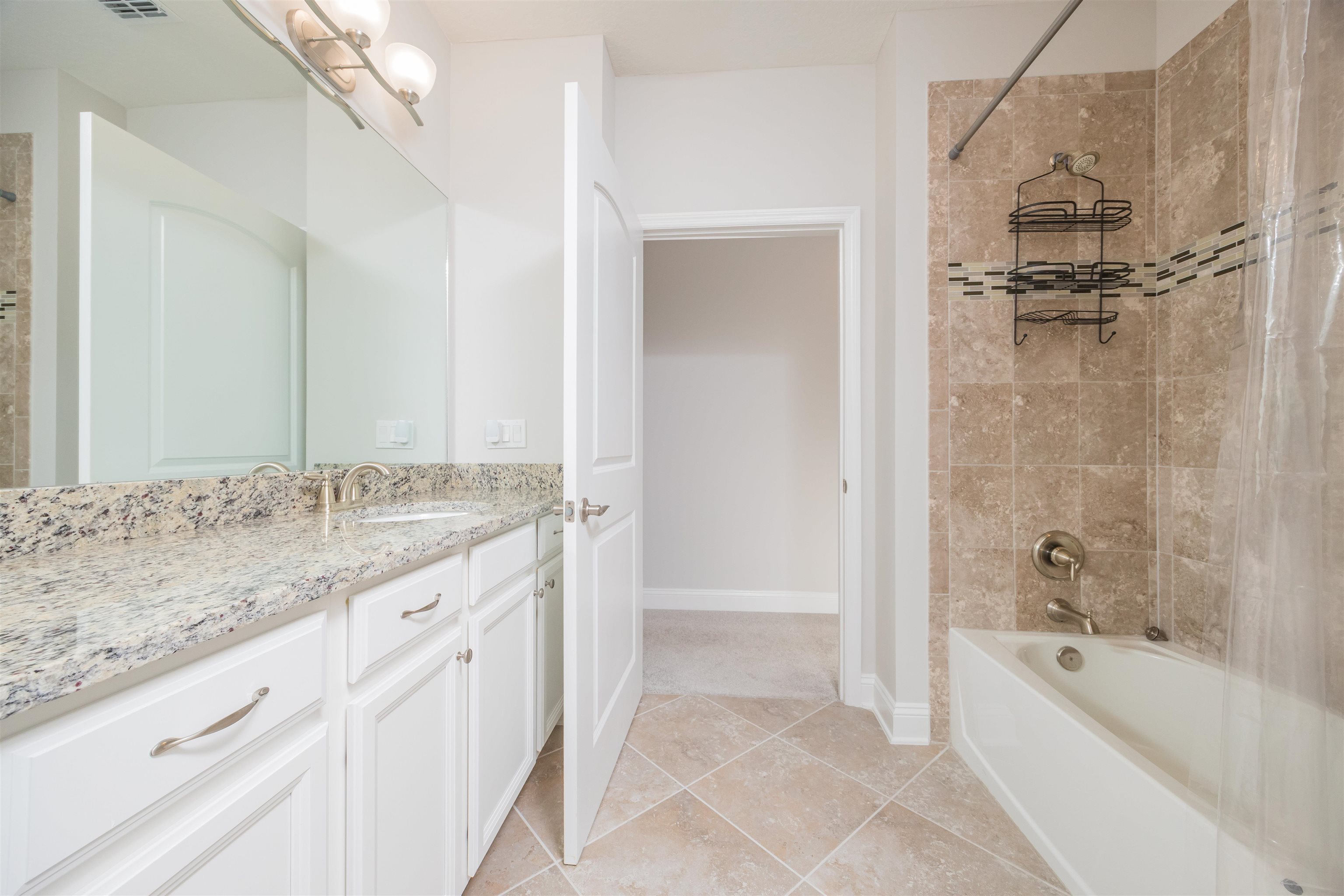 111 CanyonTrail St. Augustine, FL 32086 - Photo 41 of 55 a bathroom with a granite countertop sink a mirror bathtub and shower
