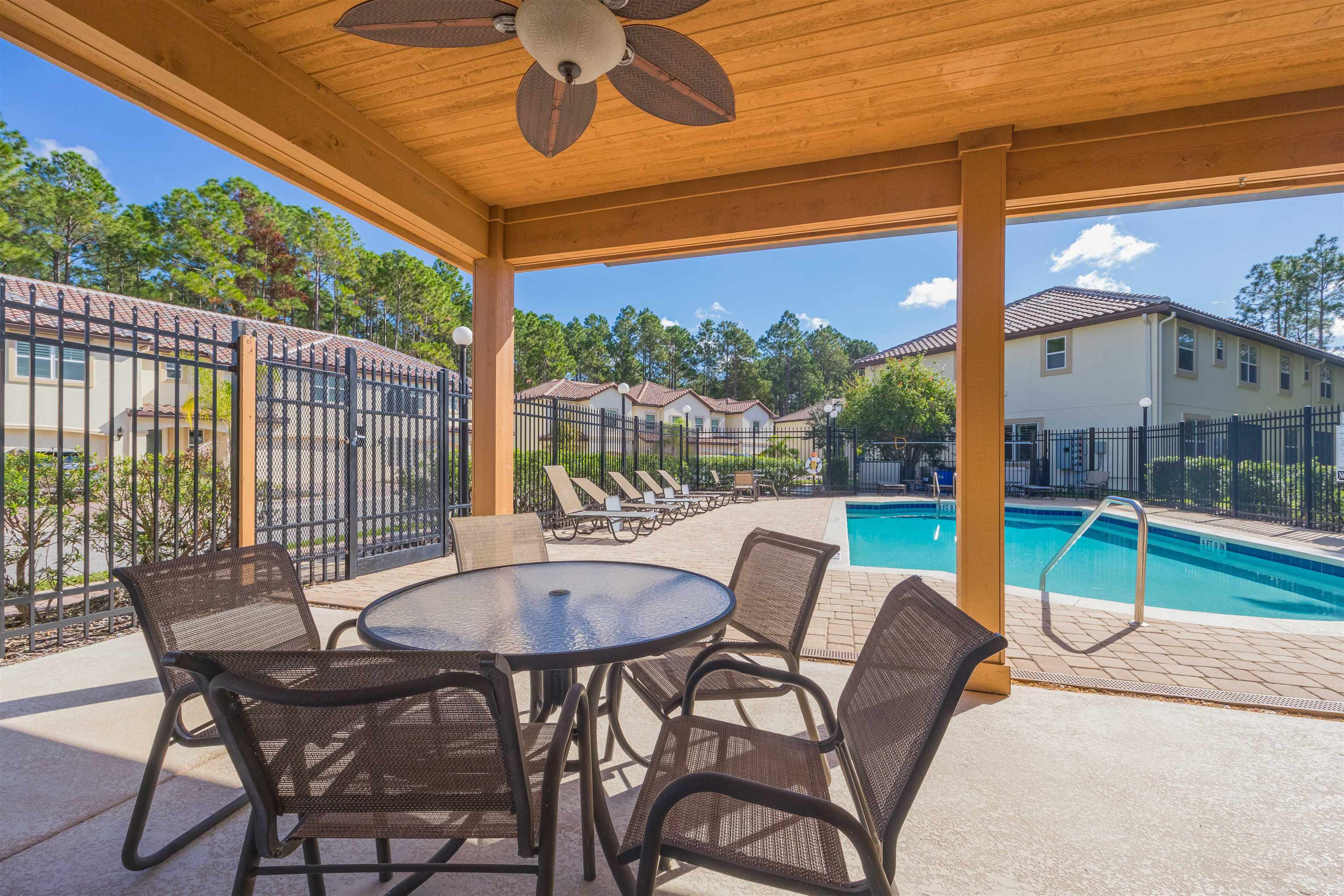 111 CanyonTrail St. Augustine, FL 32086 - Photo 55 of 55 a view of a patio with a table chairs and a backyard