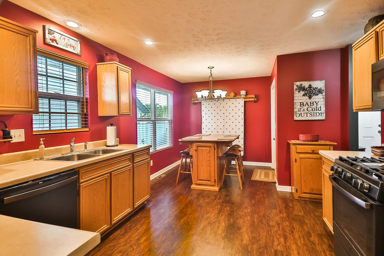 621 Grove Street Pecatonica, IL 61063 - Photo 15 of 26 a kitchen with stainless steel appliances granite countertop a sink stove and wooden floor