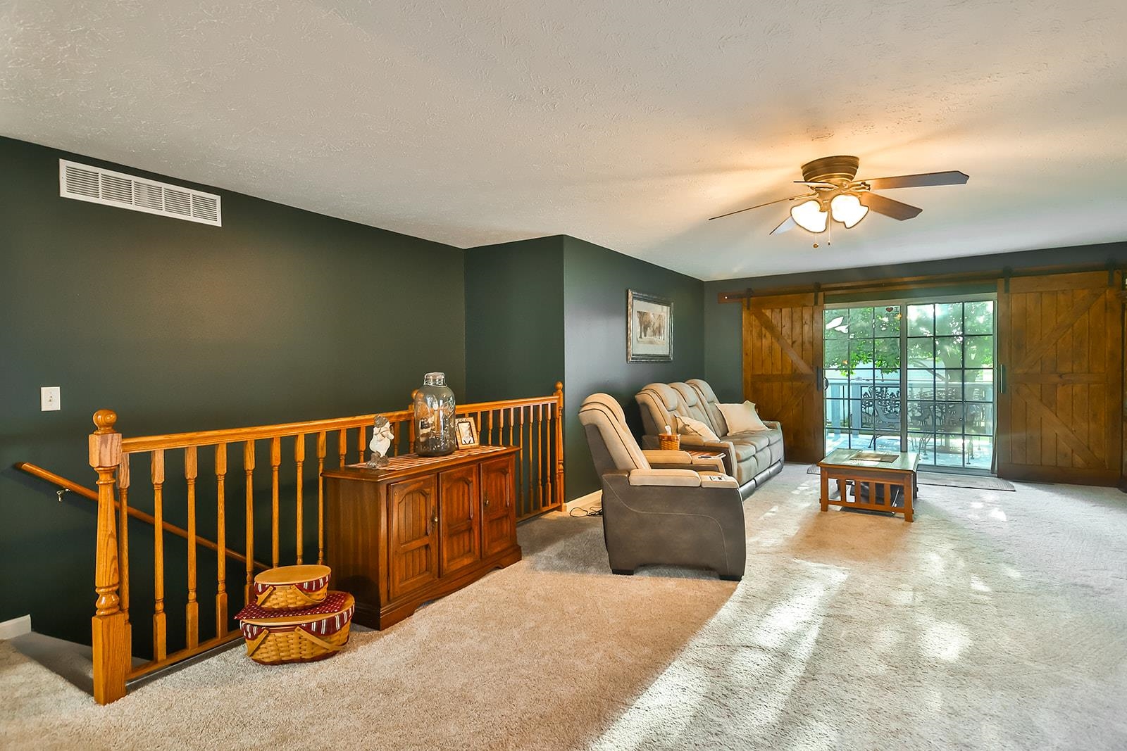 621 Grove Street Pecatonica, IL 61063 - Photo 22 of 26 a living room with furniture ceiling fan and a rug