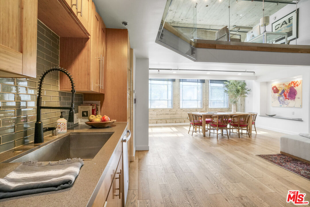 1855 Industrial Street, Unit 112 Los Angeles, CA 90021 - Photo 12 of 51 a kitchen with dining area and chandelier