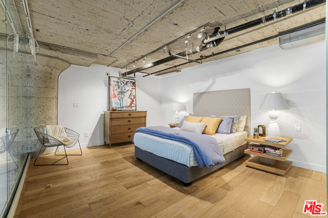 1855 Industrial Street, Unit 112 Los Angeles, CA 90021 - Photo 20 of 51 a spacious bedroom with a bed and a chair
