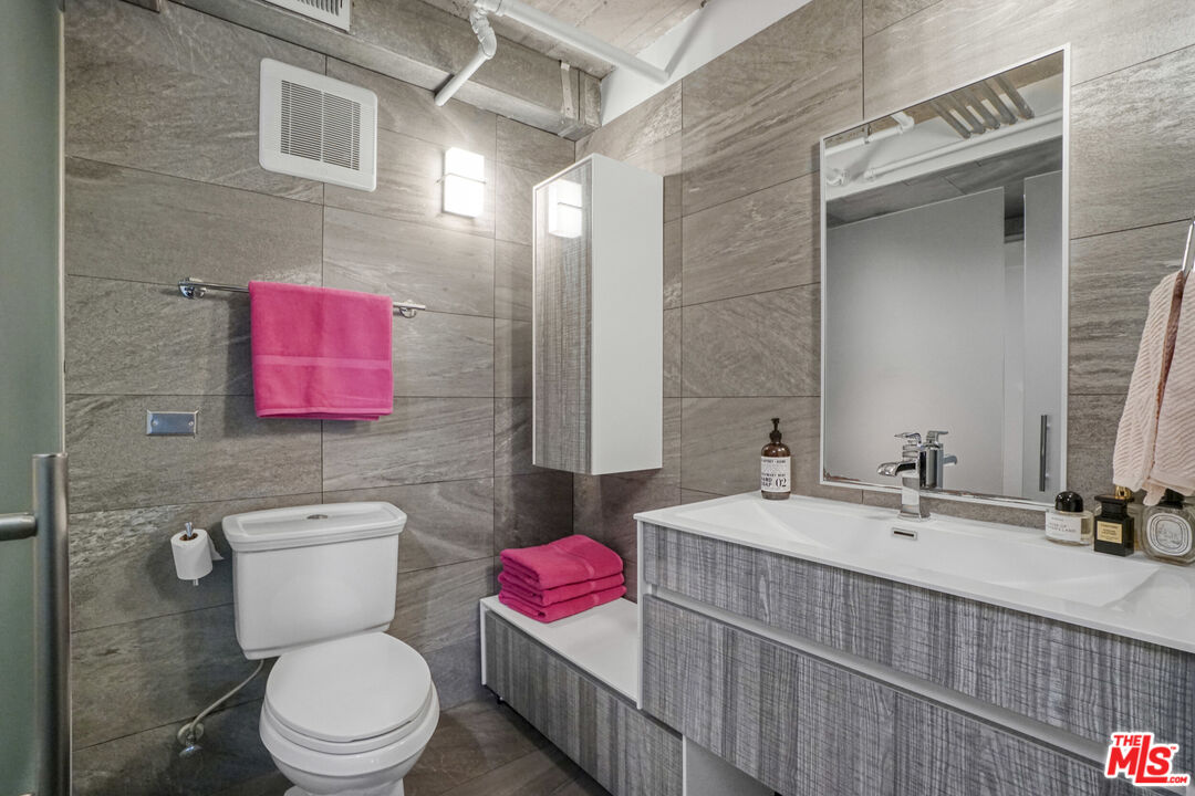 1855 Industrial Street, Unit 112 Los Angeles, CA 90021 - Photo 22 of 51 a bathroom with a toilet sink and mirror