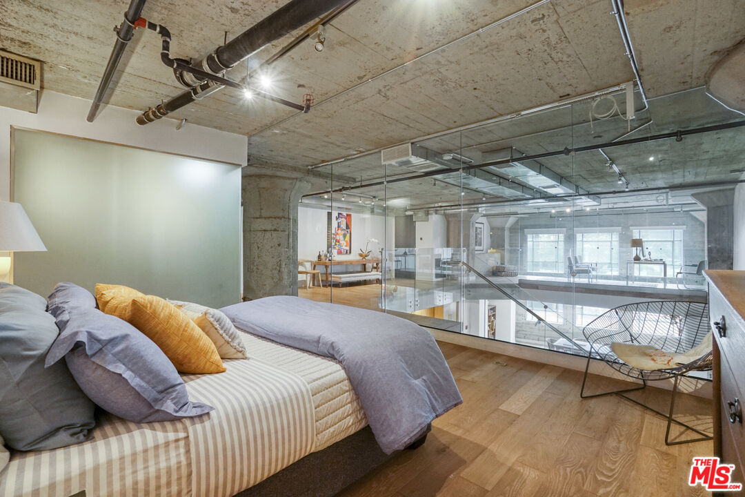 1855 Industrial Street, Unit 112 Los Angeles, CA 90021 - Photo 23 of 51 a bed room with a bed and a wooden floor
