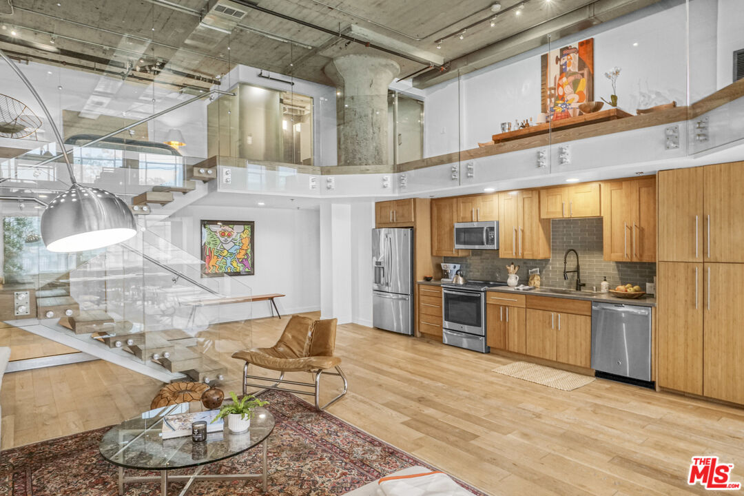 1855 Industrial Street, Unit 112 Los Angeles, CA 90021 - Photo 5 of 51 a large kitchen with stainless steel appliances granite countertop a stove and a sink