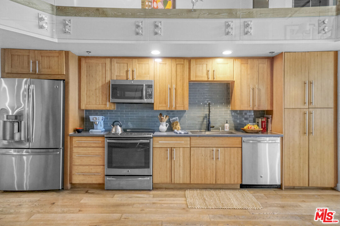 1855 Industrial Street, Unit 112 Los Angeles, CA 90021 - Photo 6 of 51 a kitchen with stainless steel appliances a stove and refrigerator