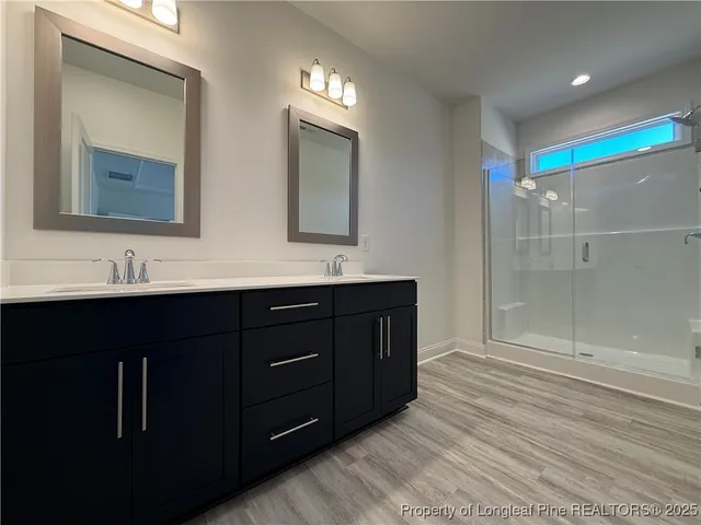 a bathroom with a sink vanity and mirror