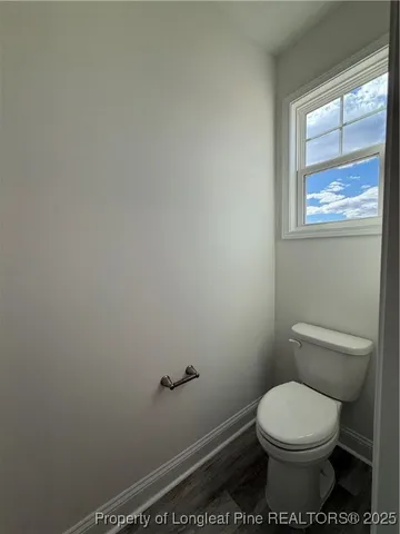 a white toilet sitting next to a window