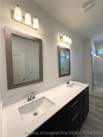 a bathroom with a sink double vanity and a mirror