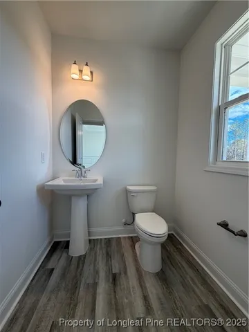 a bathroom with a toilet a sink and a window