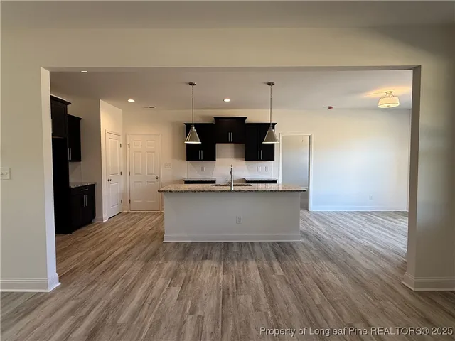 a view of kitchen with refrigerator sink and wooden floor
