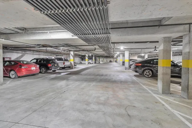 a view of parking garage with cars parked
