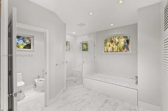 a bathroom with a tub and toilet