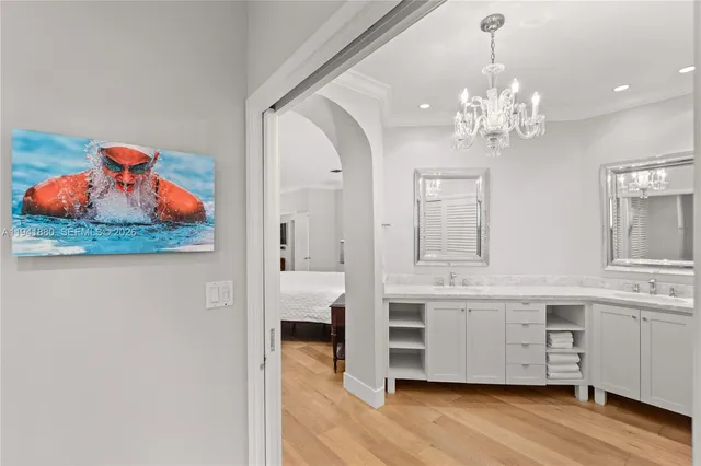 a large bedroom with a bed and wooden floor