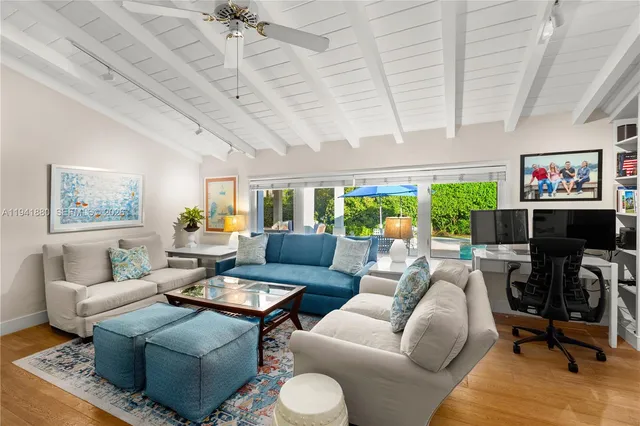 a living room with furniture ceiling fan and a rug