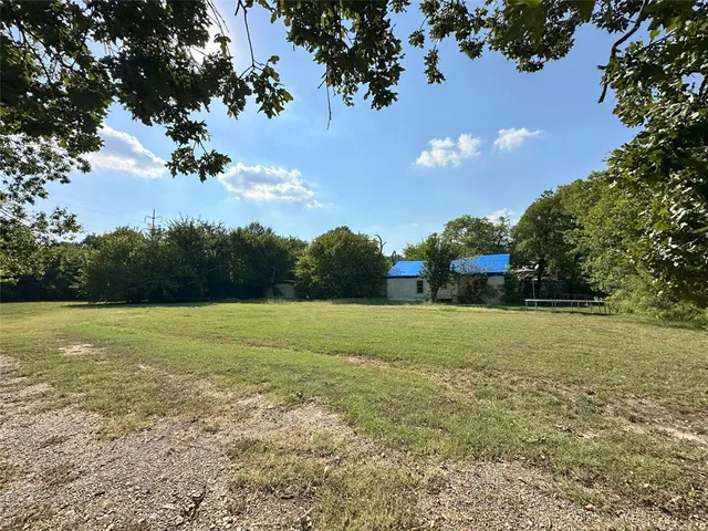 a view of a field with an trees