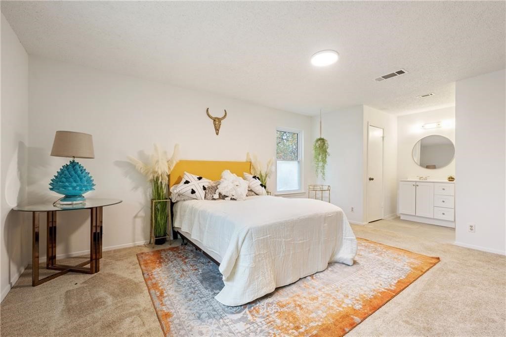 3318 Harpers Ferry Lane Austin, TX 78745 - Photo 11 of 24 a bedroom with a bed and window