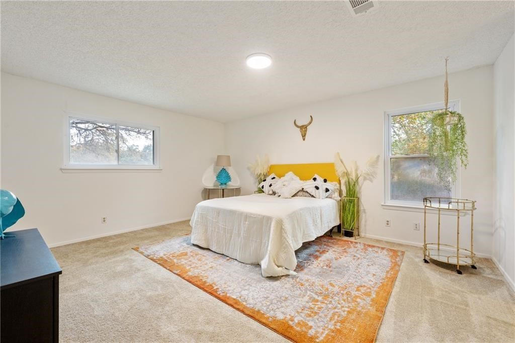 3318 Harpers Ferry Lane Austin, TX 78745 - Photo 12 of 24 a bedroom with a bed and a window