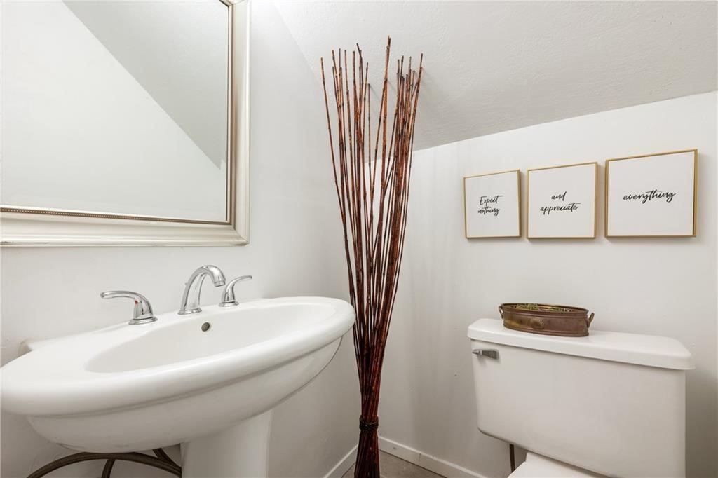 3318 Harpers Ferry Lane Austin, TX 78745 - Photo 13 of 24 a bathroom with a sink a toilet and a mirror