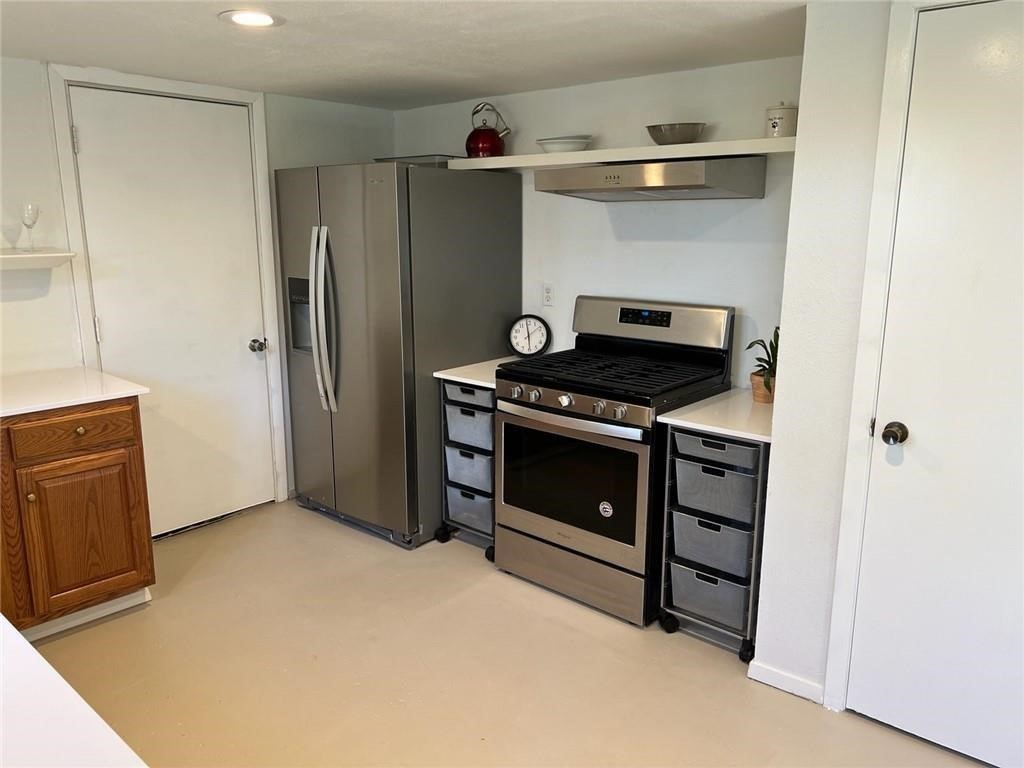 3318 Harpers Ferry Lane Austin, TX 78745 - Photo 14 of 24 a kitchen with stainless steel appliances a stove and a refrigerator