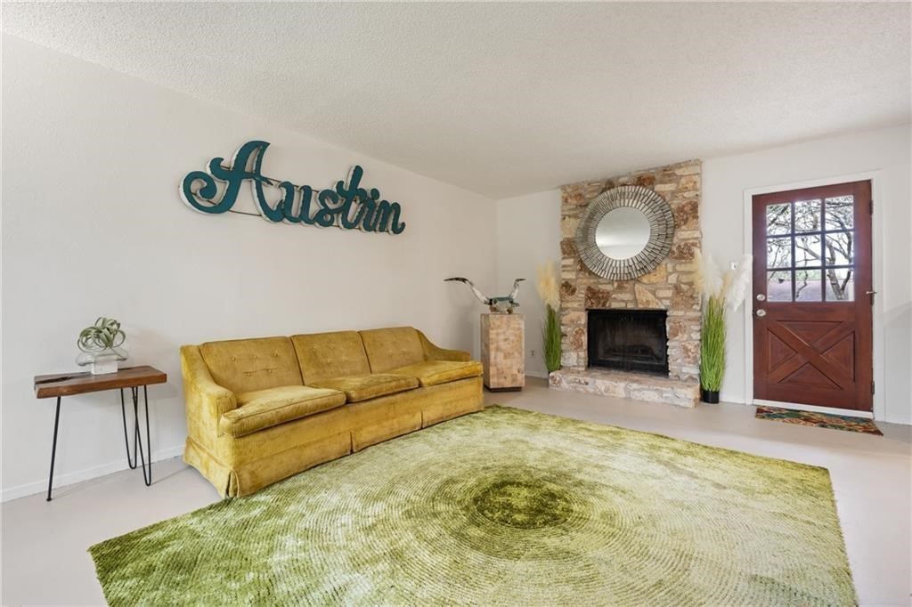 3318 Harpers Ferry Lane Austin, TX 78745 - Photo 22 of 24 a living room with furniture and a fireplace