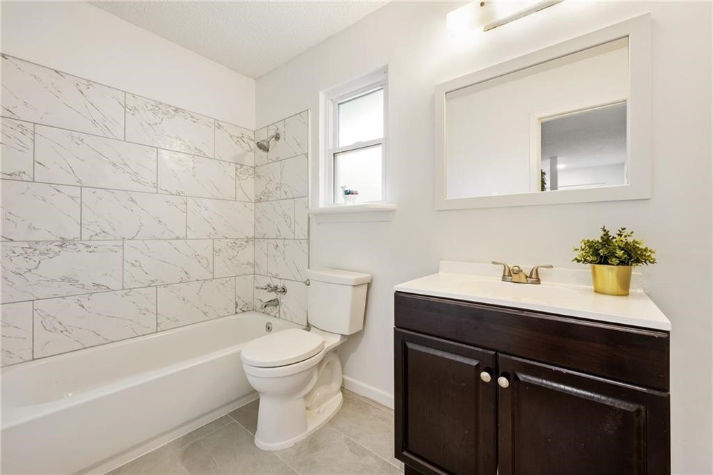 3318 Harpers Ferry Lane Austin, TX 78745 - Photo 4 of 24 a bathroom with a sink a toilet and shower