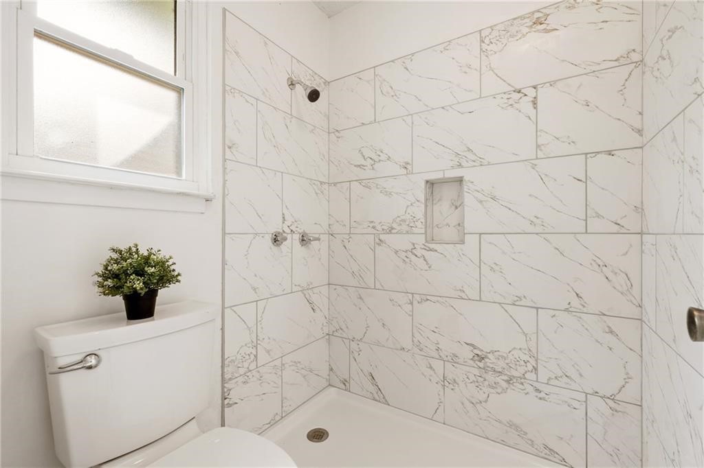 3318 Harpers Ferry Lane Austin, TX 78745 - Photo 8 of 24 a bathroom with a bathtub and a shower