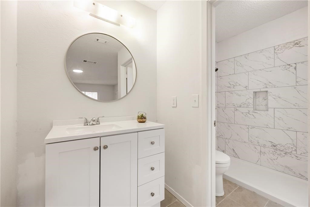 3318 Harpers Ferry Lane Austin, TX 78745 - Photo 9 of 24 a bathroom with a sink and a mirror