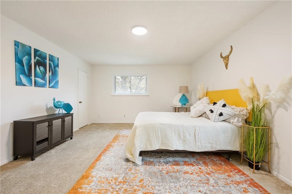 3318 Harpers Ferry Lane Austin, TX 78745 - Photo 10 of 24 a bedroom with a bed and a window