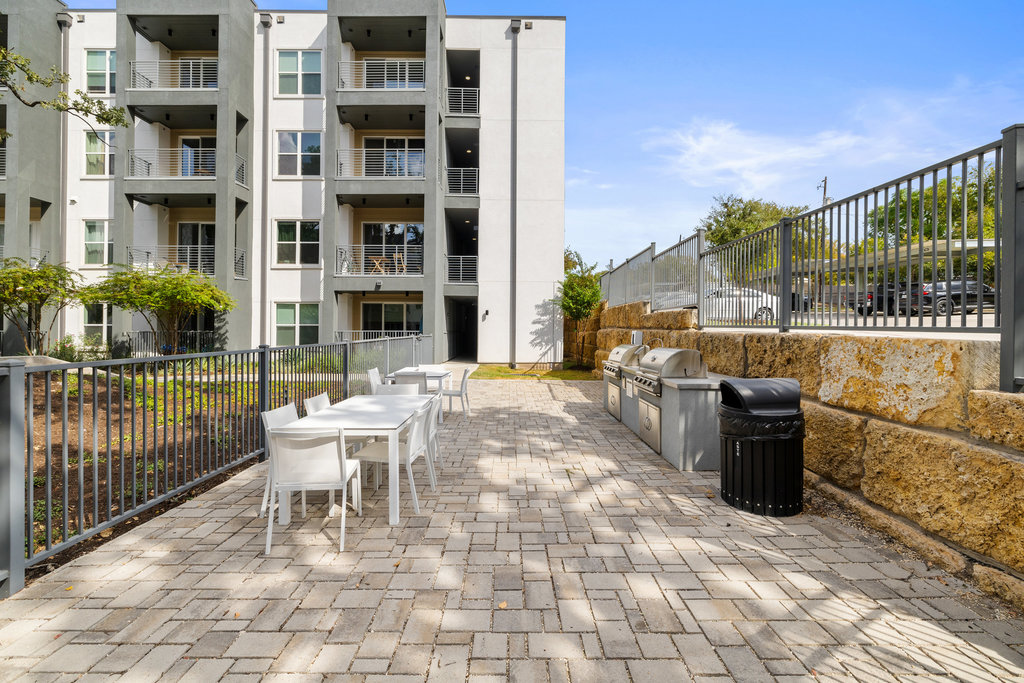 4801 Springdale Road, Unit 1106 Austin, TX 78723 - Photo 17 of 40 a view of a patio with couches and table and chairs and potted plants