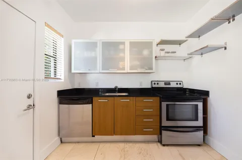 a kitchen with stainless steel appliances granite countertop a stove and a microwave