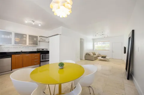 a view of a kitchen with granite countertop a sink a stove and a refrigerator