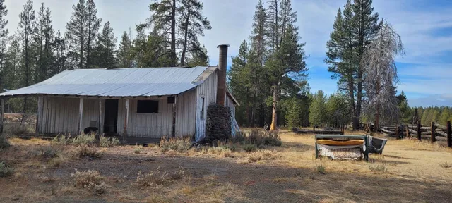a view of a patio with a table and chairs under an umbrella