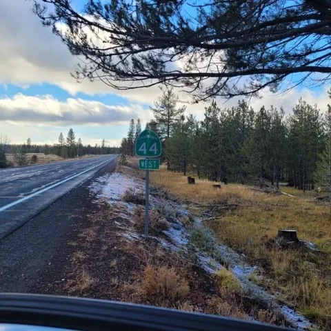 a view of a yard with wooden fence